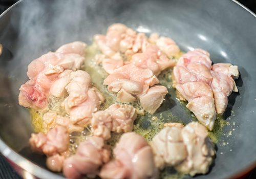 Macro closeup of fresh whole beef sweetbreads thymus organ gland, nutritious ancestral meat homemade food cooking frying on pan with steam