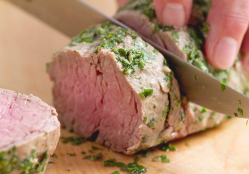 Steamed veal fillet being sliced